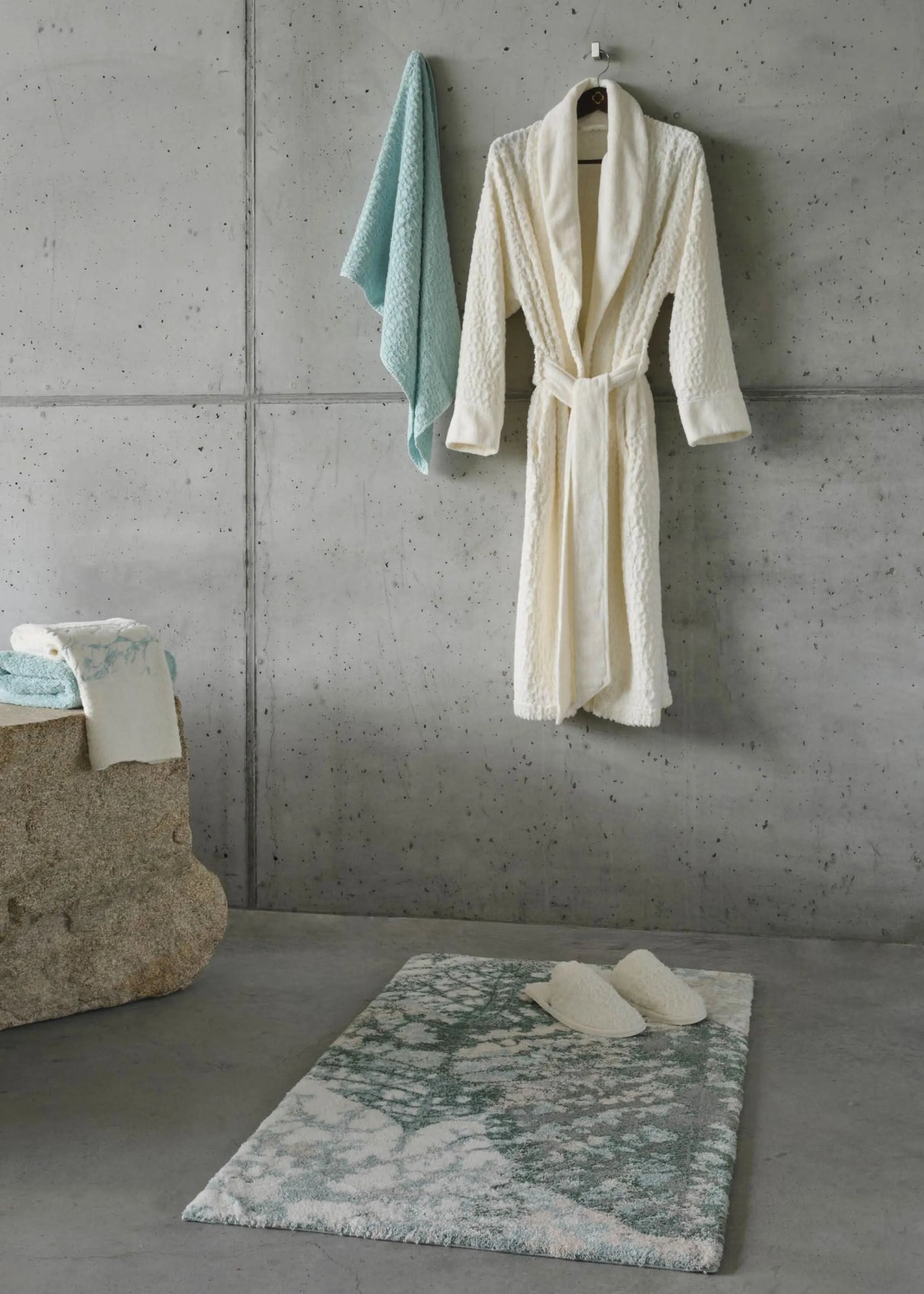 A&H Monoke Bath Rug. A&H Lodge Towel (235 Ice), Robe and Slippers (103 Ivory). A&H Alpi Hand Towel in 235 Ice (left)