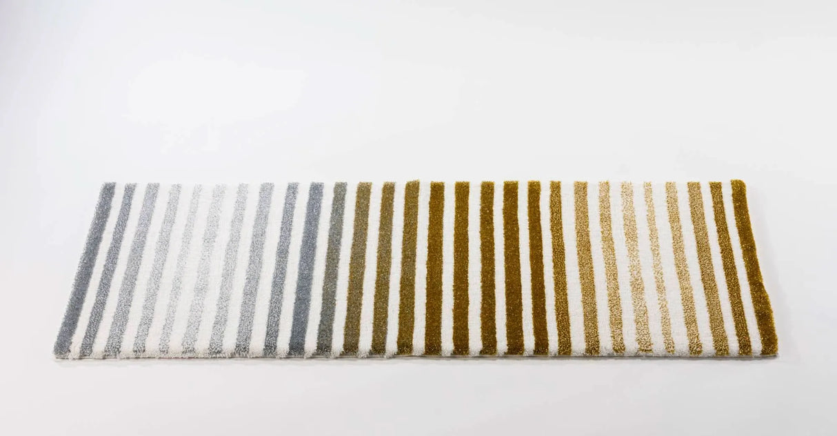 The A&H Barns Bath Rug is a striped runner/dual vanity rug. Colours include 100 White, 103 Ivory, 840 Gold, 930 Perle and 992 Platinum