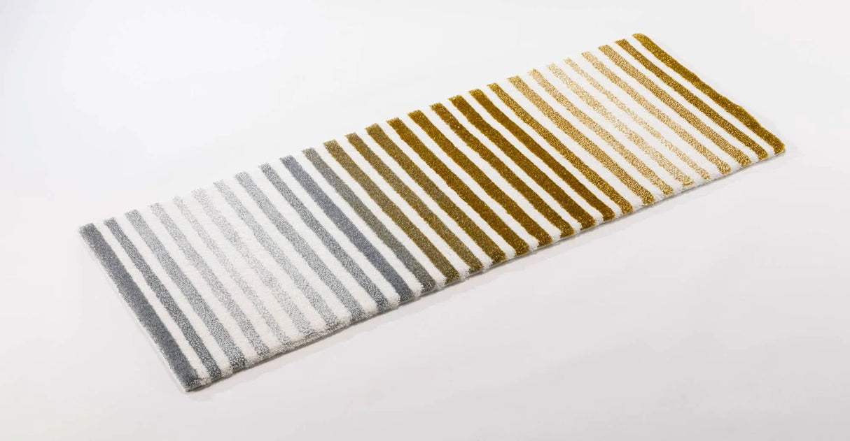 The A&H Barns Bath Rug is a striped runner/dual vanity rug. Colours include 100 White, 103 Ivory, 840 Gold, 930 Perle and 992 Platinum