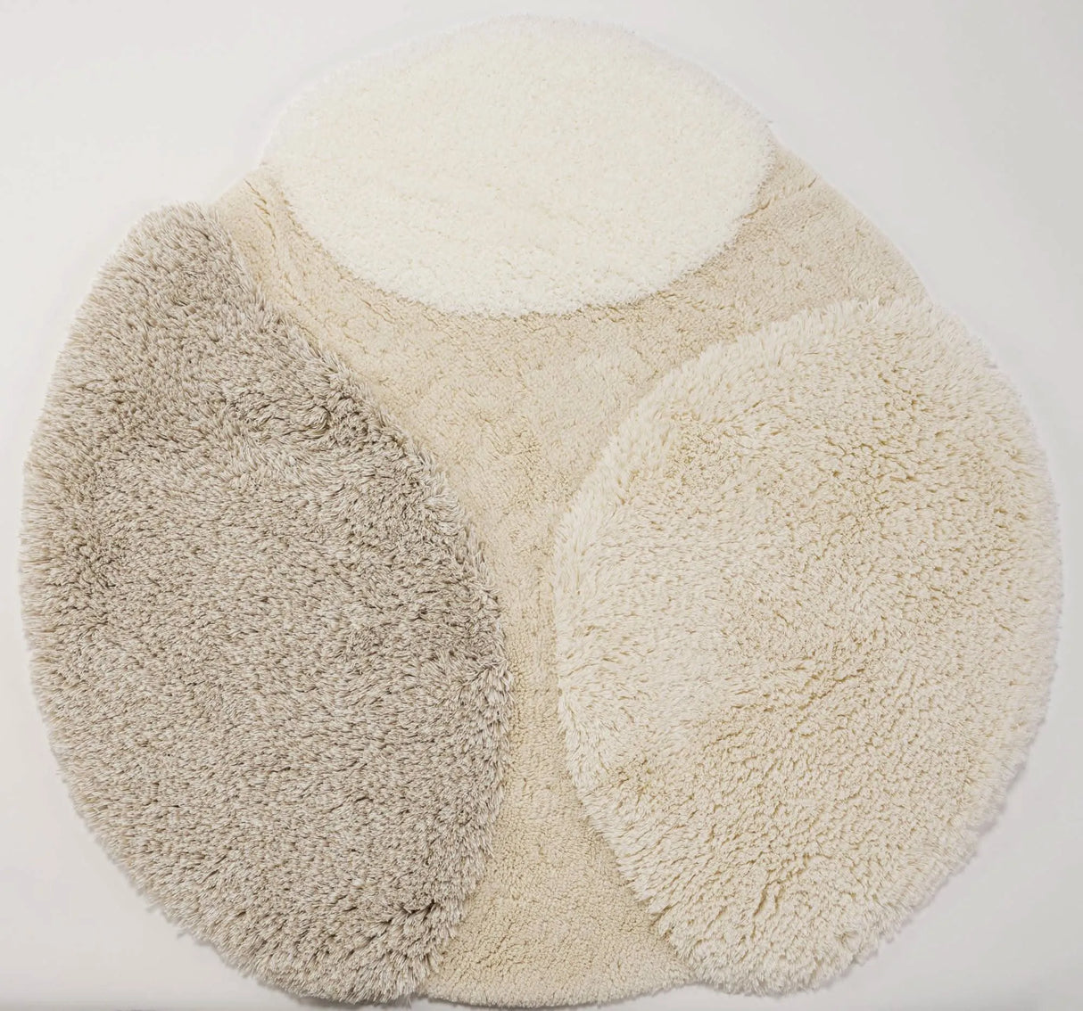 A&H Cordeira Bath Rugs feature white, ecru, ivory and linen tones and are available in two unique shapes and sizes