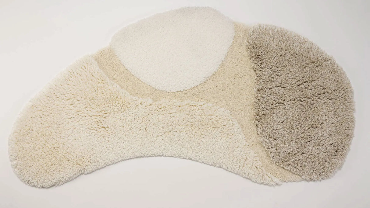 A&H Cordeira Bath Rugs feature white, ecru, ivory and linen tones and are available in two unique shapes and sizes
