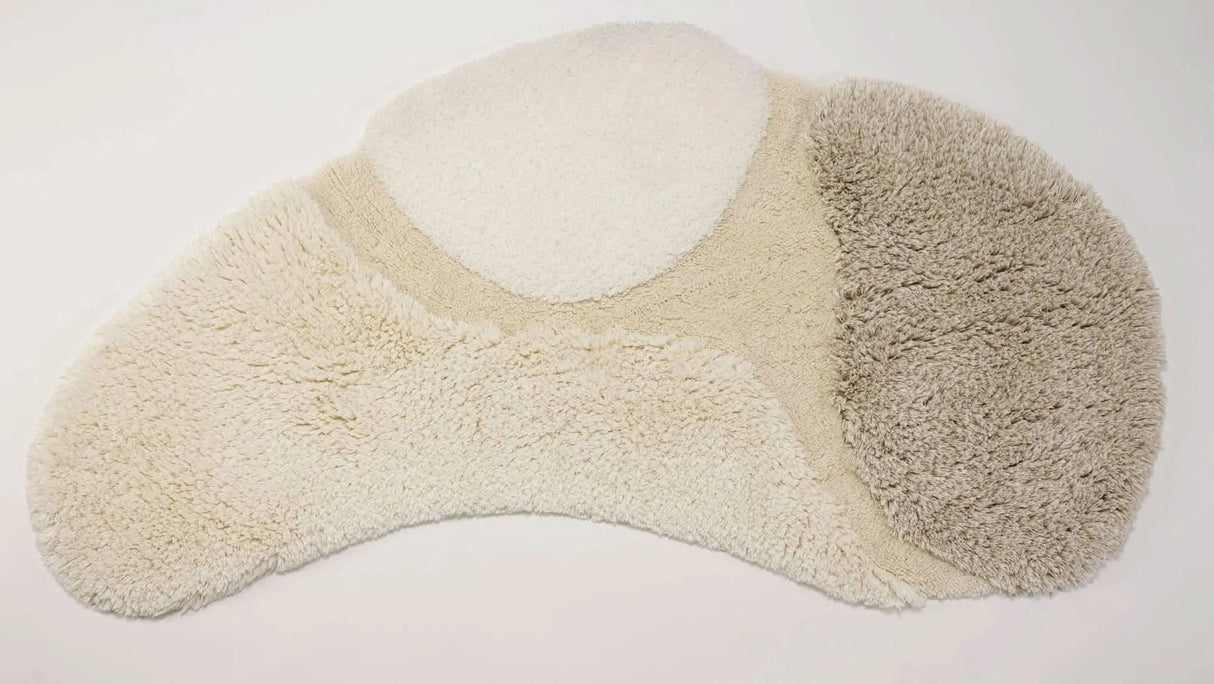 A&H Cordeira Bath Rugs feature white, ecru, ivory and linen tones and are available in two unique shapes and sizes