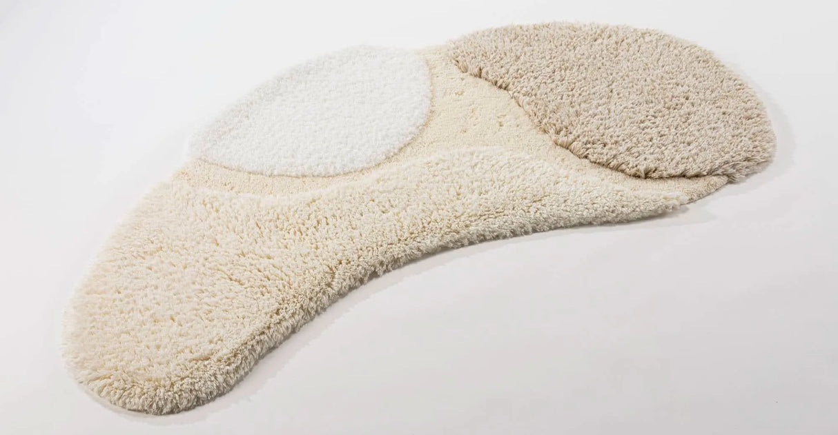 A&H Cordeira Bath Rugs feature white, ecru, ivory and linen tones and are available in two unique shapes and sizes