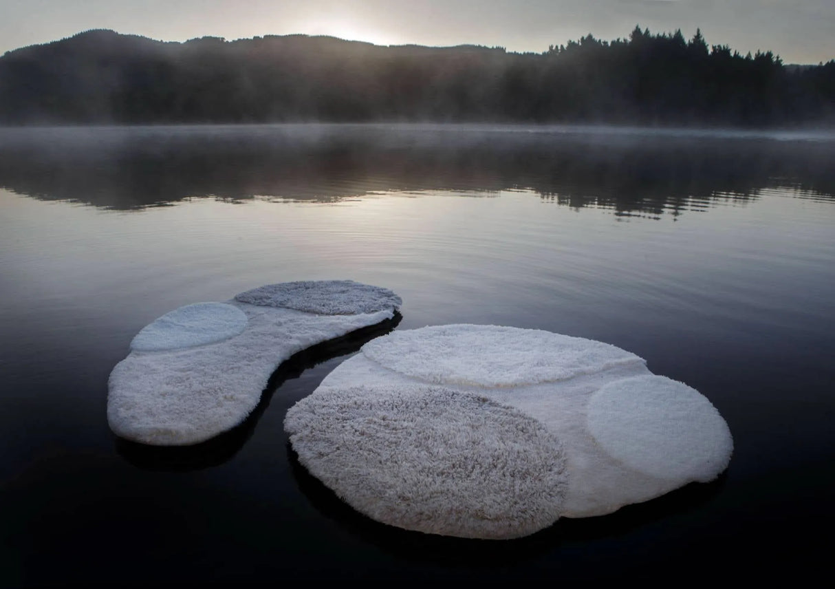 A&H Cordeira Bath Rugs feature white, ecru, ivory and linen tones and are available in two unique shapes and sizes