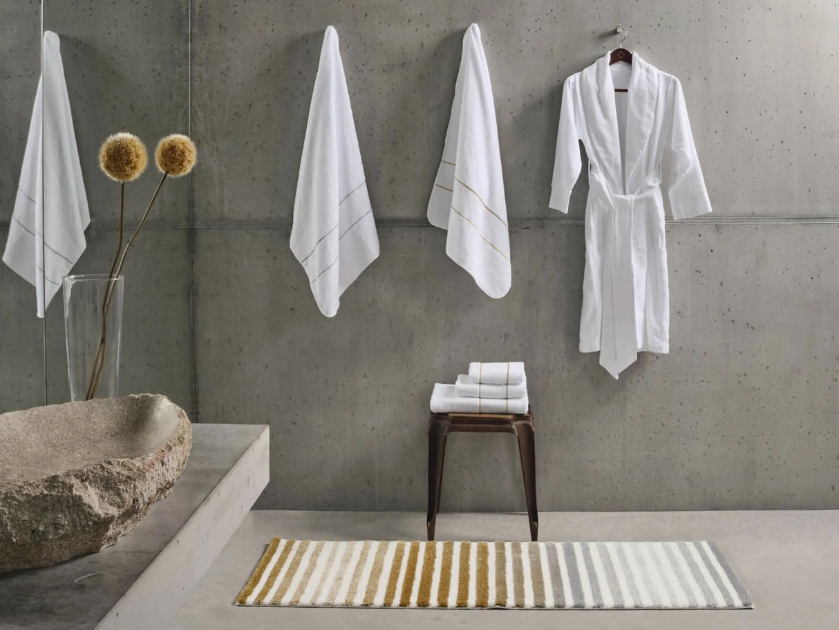 Rug: A&H Barns. Towels: A&H Lara Embroidered Towels. Robe: A&H Amigo Robe in 100 White