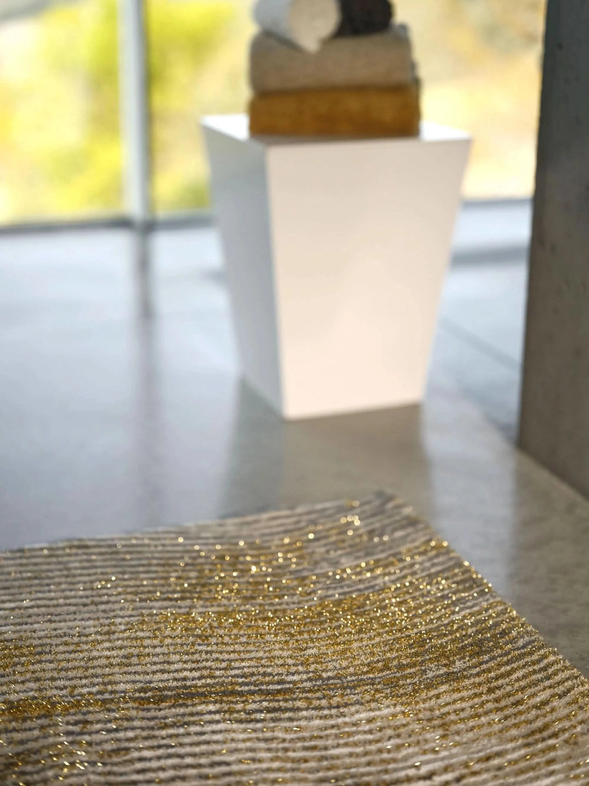 The A&H Lana Bath Rug features a striking striped design in gold, ivory and grey tones