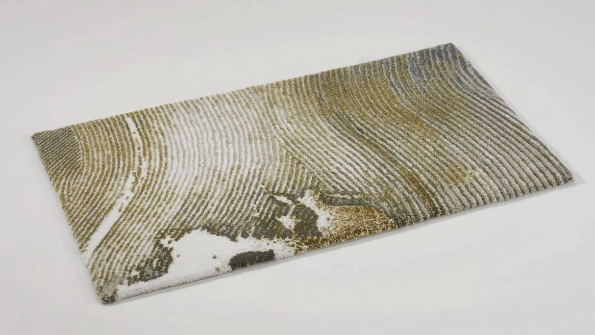 The A&H Lana Bath Rug features a striking striped design in gold, ivory and grey tones