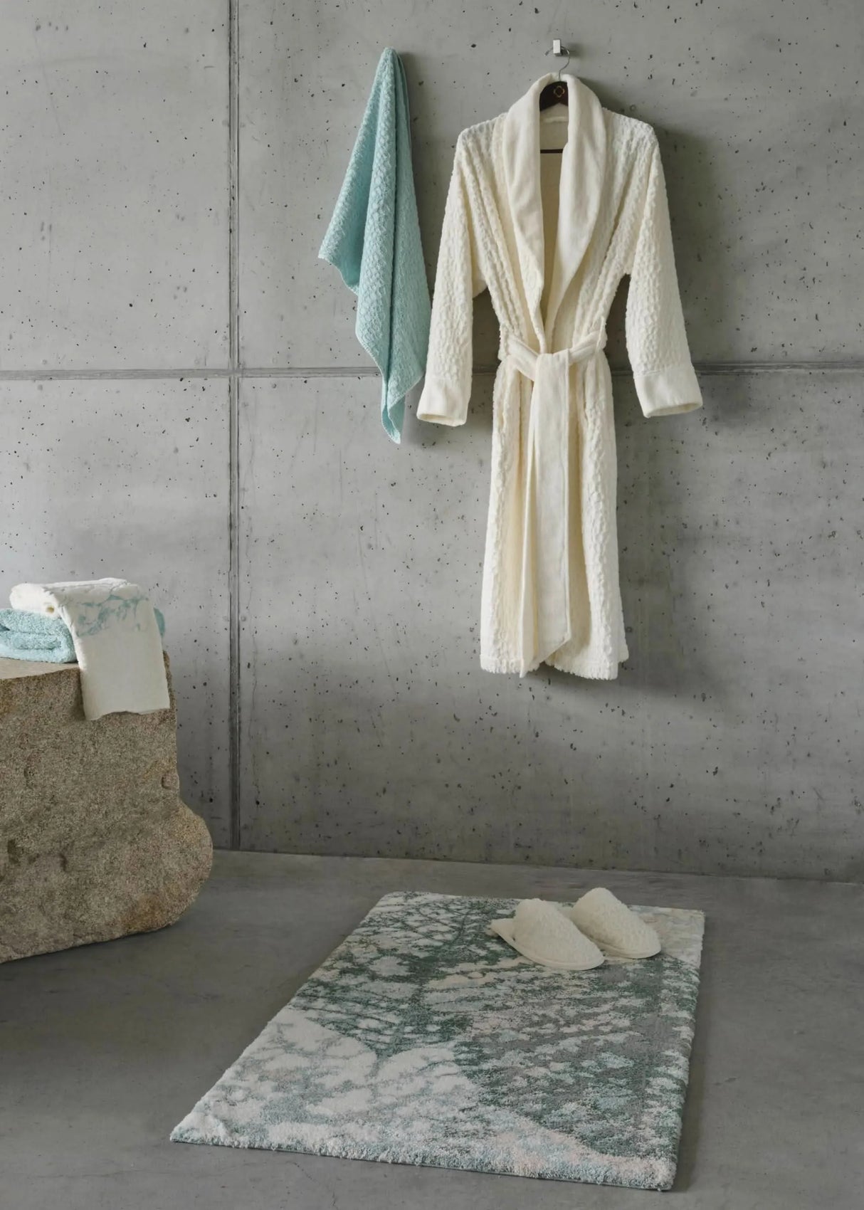 A&H Monoke Bath Rug. A&H Lodge Towel (235 Ice), Robe and Slippers (103 Ivory). A&H Alpi Hand Towel in 235 Ice (left)