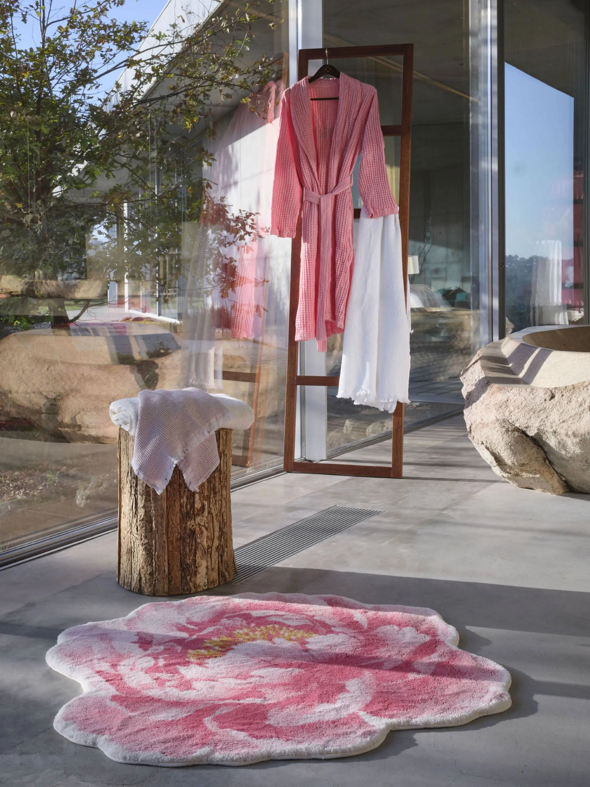 A&H Pivoine Bath Rug & A&H Pousada Robe in 573 Flamingo, A&H Bees Towel in 518 Primrose (on log), A&H Bees Towel in 100 White (next to robe)