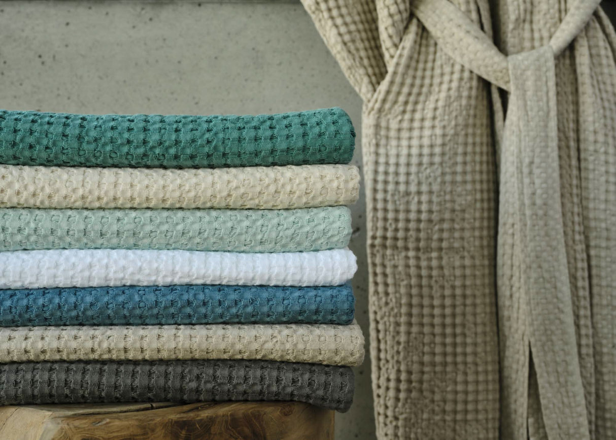 A&H Pousada Waffle Towels (top-to-bottom) in 302 Lagoon, 101 Ecru, 235 Ice, 100 White, 325 Dragonfly, 770 Linen and 920 Gris. A&H Pousada Robe in 770 Linen