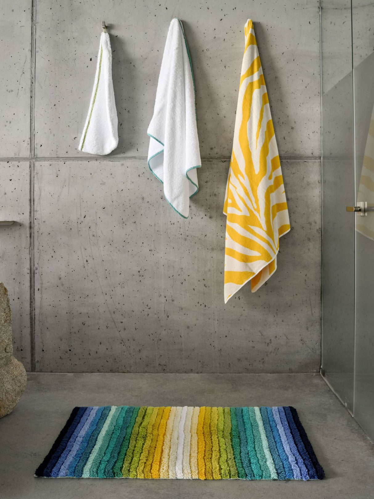 The A&H Santa Cruz Bath Rug in 302 Lagoon. Towels left: Surf Hair Towel in 165 Apple Green, Surf Bath Towel in 302 Lagoon and Zebra Beach Towel in 830 Banane