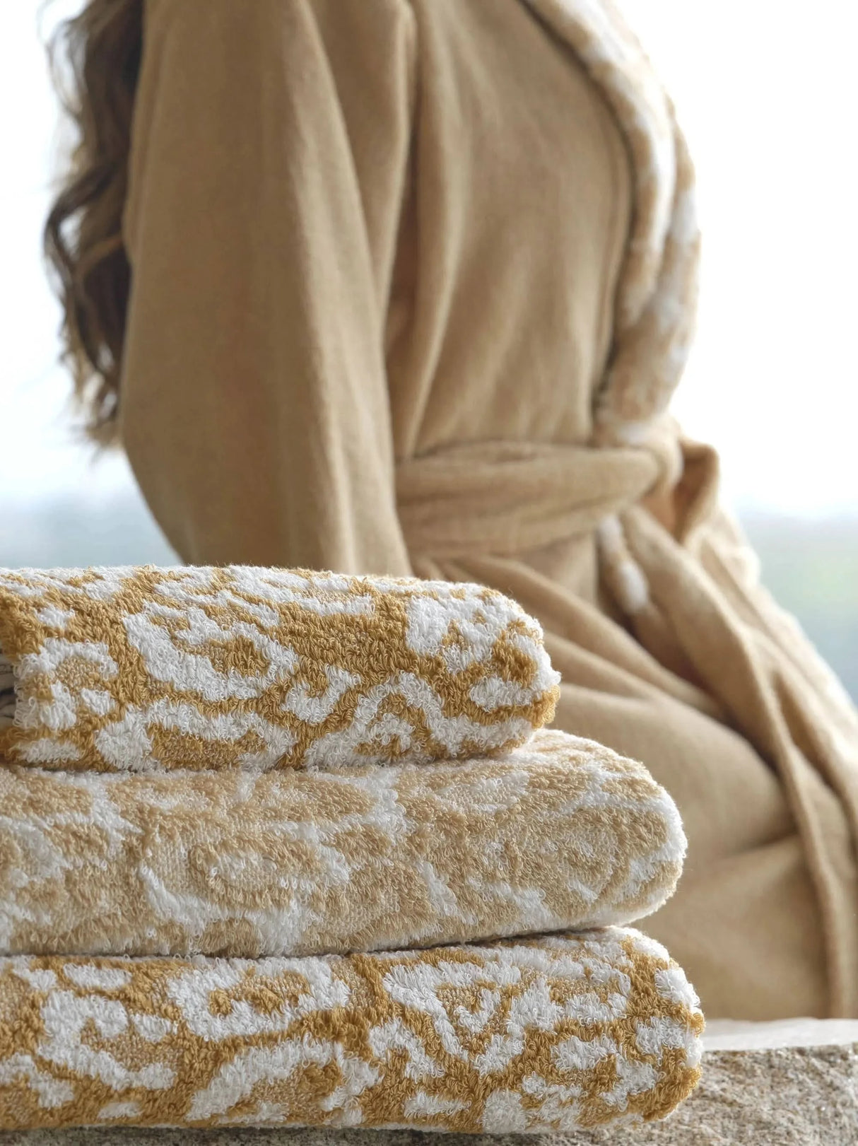 A&H Sauvage Towels, top-to-bottom: 840 Gold, 714 Sand, 840 Gold. A&H Sauvage Robe in 714 Sand