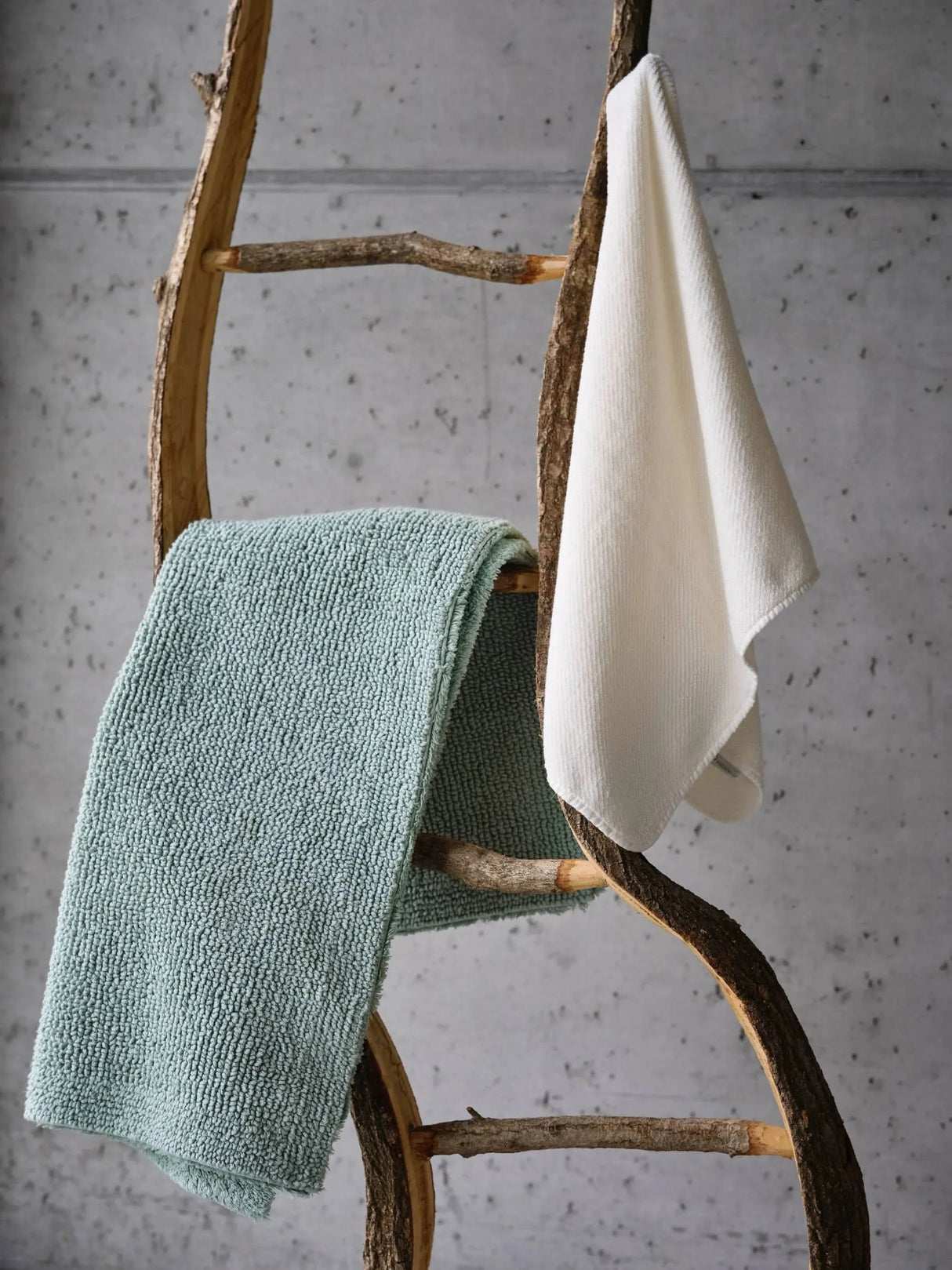 A&H Reversible Rug in 210 Aqua (Left) and A&H Twill Hair Towel in 103 Ivory (Right)
