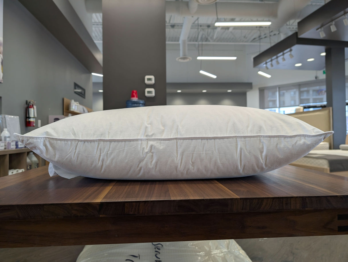 St Geneve Aspen Pillow in Firm fill, queen size, in our Sherwood Park store on a TEAM 7 Magnum dining table