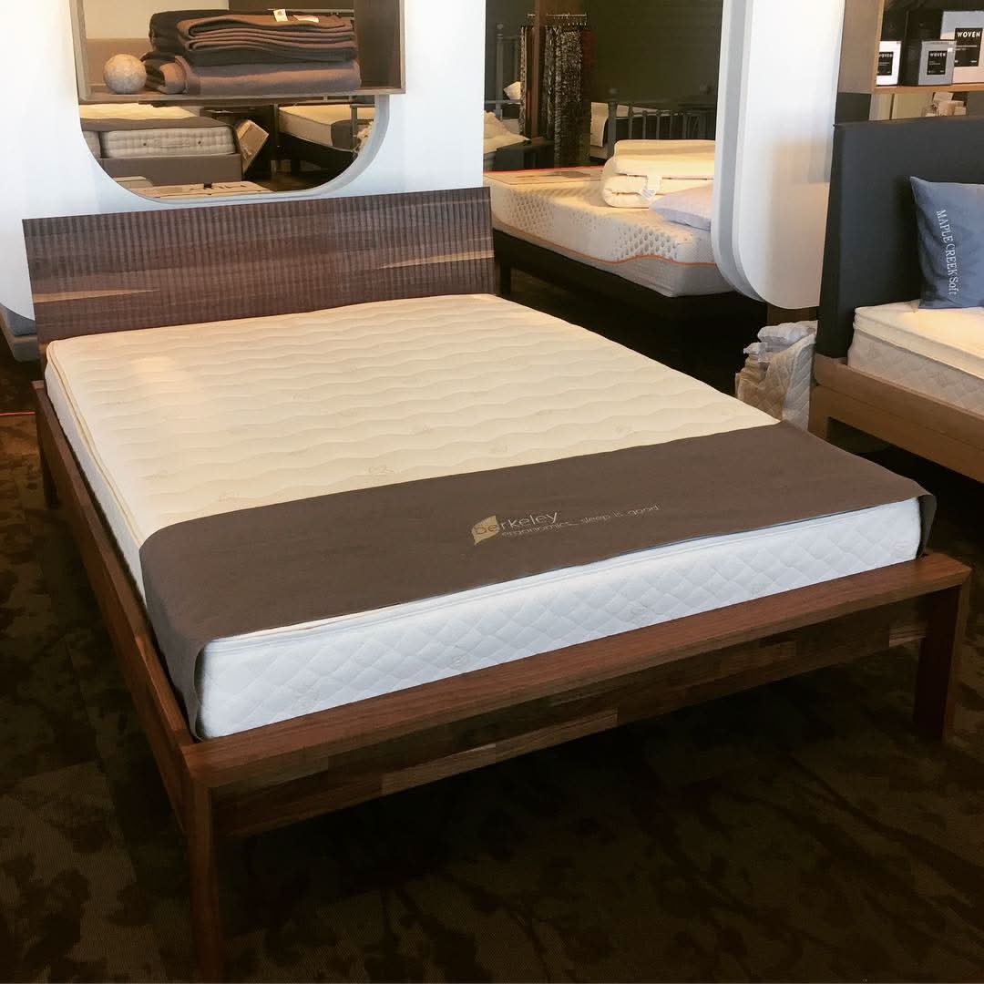 TEAM 7 lunetto bed in walnut with relief headboard. Shown here in our Calgary store w/ a Berkeley Ergonomics Berlin mattress