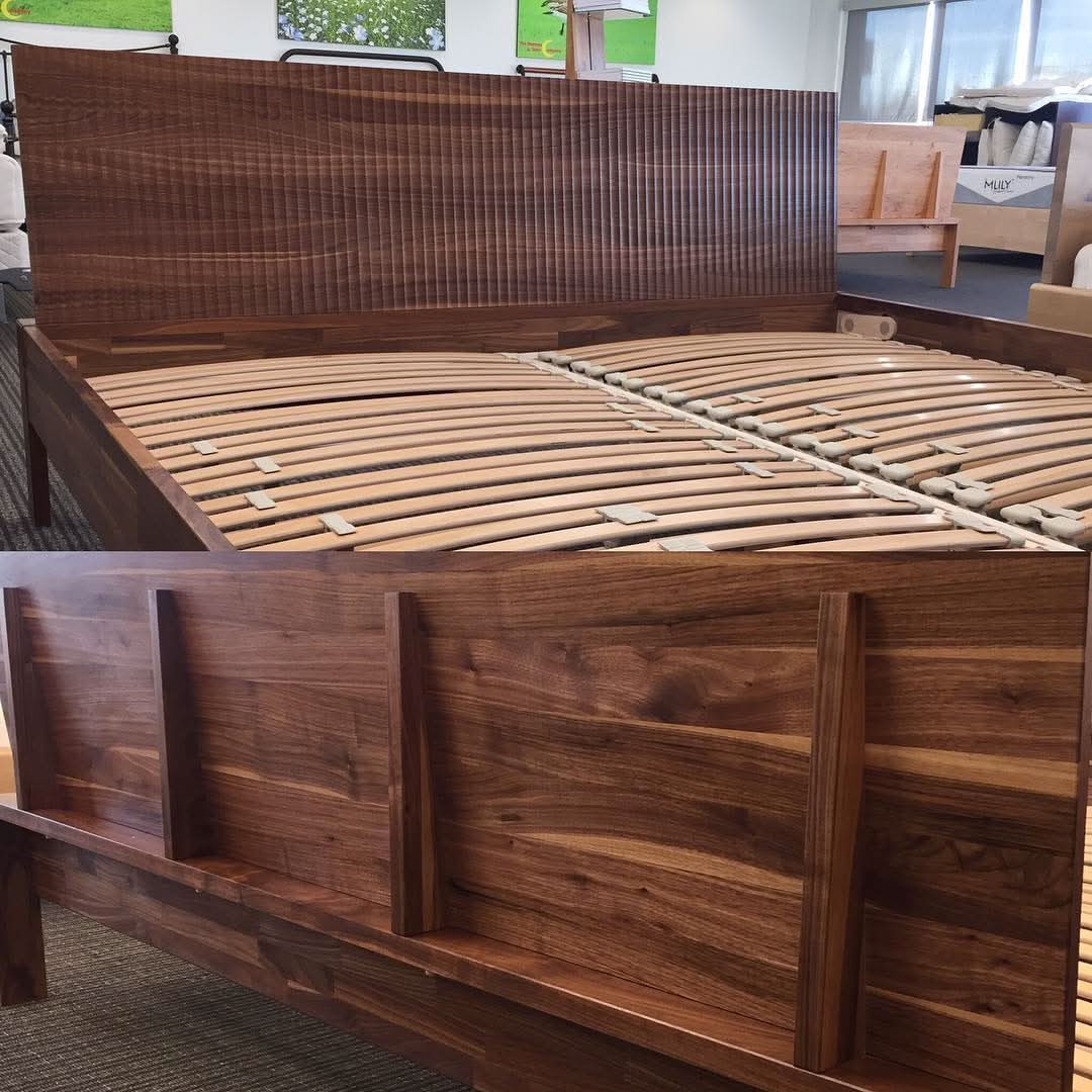 TEAM 7 lunetto bed in walnut w/ relief headboard. Berkeley Ergonomics suspension slats. Photographed in our Edmonton store