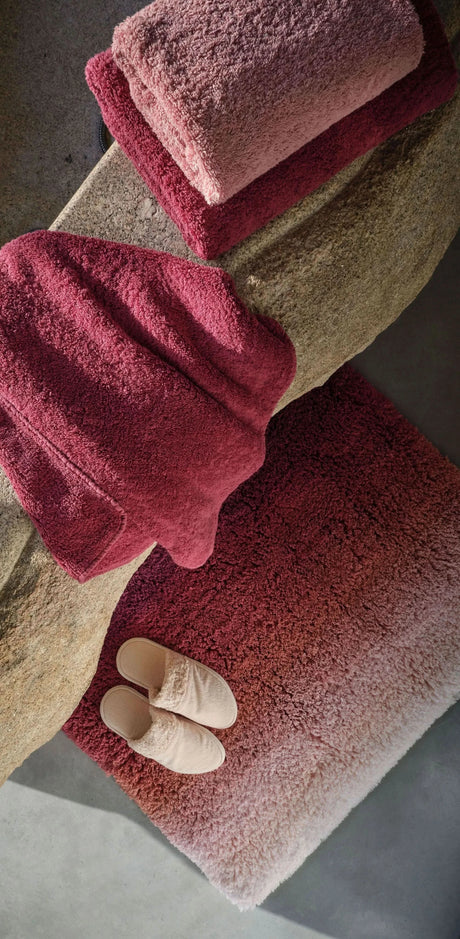 Aurore Bath Rug in 514 Baton Rouge. Super Pile Towels in 514 Baton Rouge and 515 Rosette. Comfy Slippers in 610 Nude