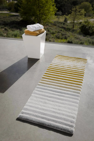 The A&H Barns Bath Rug is a striped runner/dual vanity rug. Colours include 100 White, 103 Ivory, 840 Gold, 930 Perle and 992 Platinum
