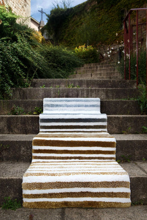 The A&H Barns Bath Rug is a striped runner/dual vanity rug. Colours include 100 White, 103 Ivory, 840 Gold, 930 Perle and 992 Platinum