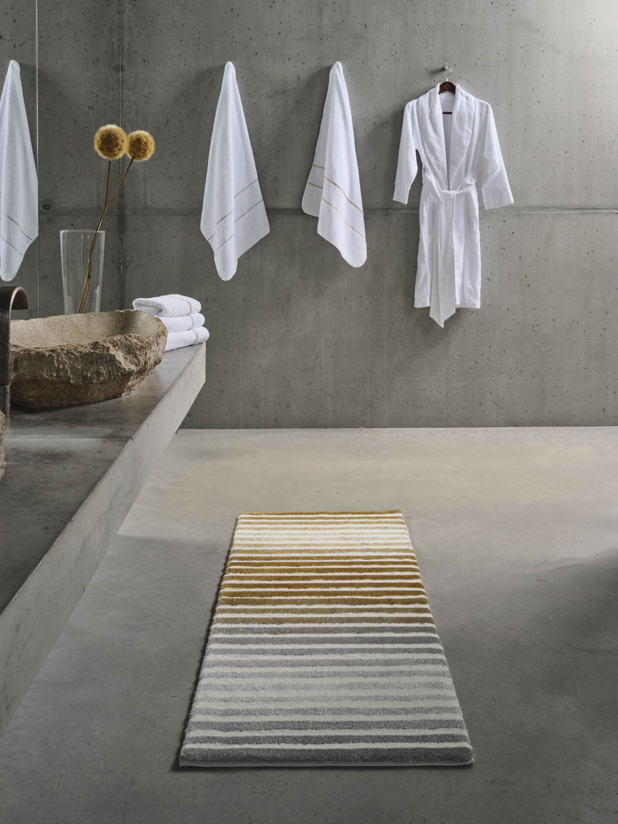 Rug: A&H Barns. Towels: A&H Lara Embroidered Towels. Robe: A&H Amigo Robe in 100 White