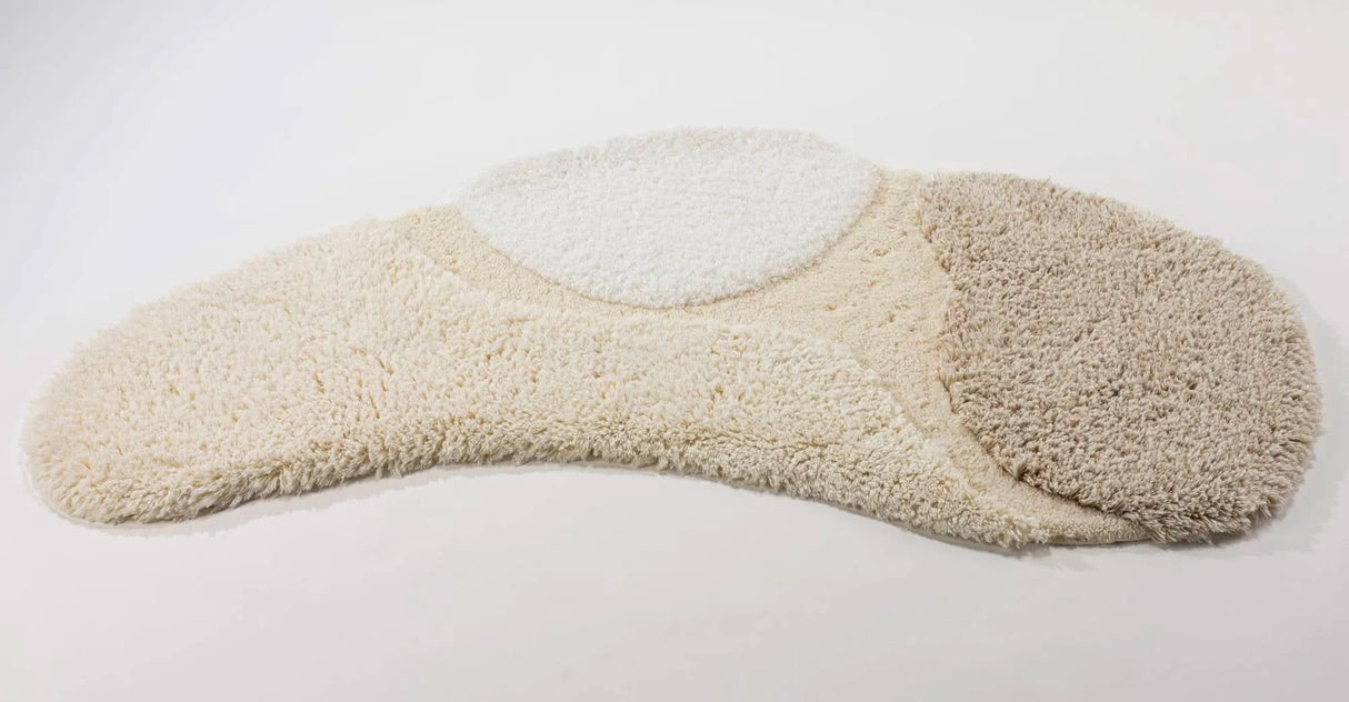 A&H Cordeira Bath Rugs feature white, ecru, ivory and linen tones and are available in two unique shapes and sizes