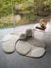 A&H Cordeira Bath Rugs feature white, ecru, ivory and linen tones and are available in two unique shapes and sizes