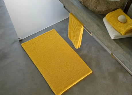 A&H Double Tub Mat (floor) in 830 Banane. A&H Super Pile Towels (on vanity) in 830 Banane and 100 White. Hanging towel is discontinued