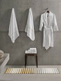 Rug: A&H Barns. Towels: A&H Lara Embroidered Towels. Robe: A&H Amigo Robe in 100 White