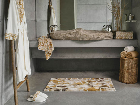 A&H Sauvage Towel in 840 Gold (left vanity), 714 Sand on 840 Gold (right vanity). A&H Sauvage Robe & Slippers in 840 Gold. A&H Gigi Rug in 840 Gold