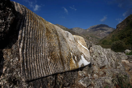 The A&H Lana Bath Rug features a striking striped design in gold, ivory and grey tones
