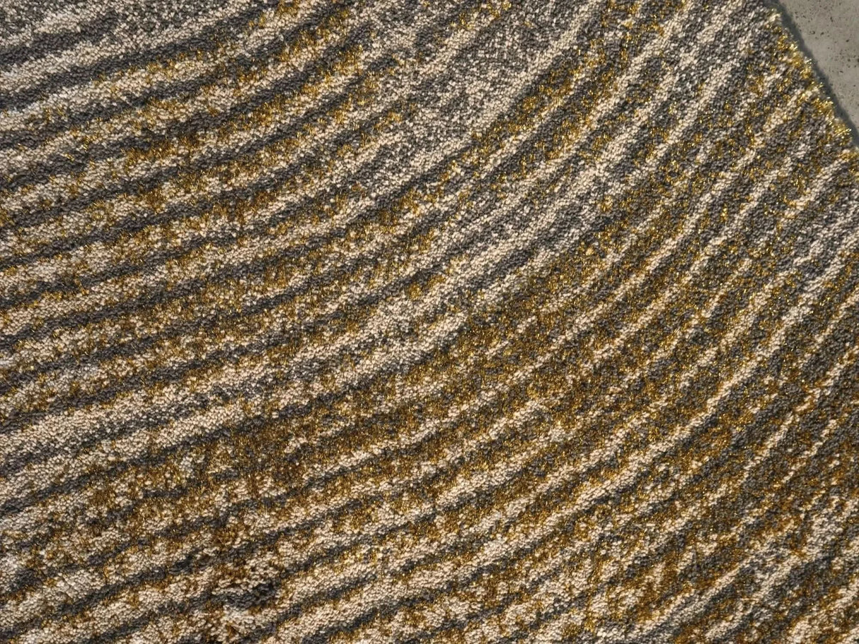The A&H Lana Bath Rug features a striking striped design in gold, ivory and grey tones