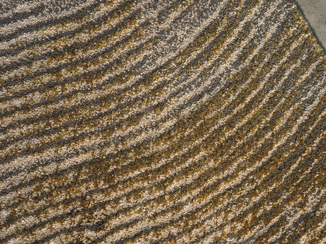 The A&H Lana Bath Rug features a striking striped design in gold, ivory and grey tones