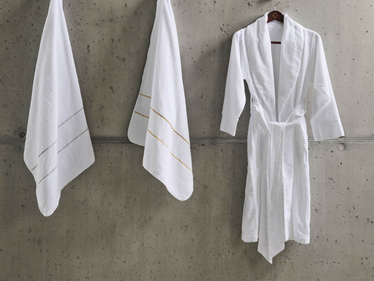 A&H Lara Embroidered Towels. Left: 109 Silver, Right: 108 Gold. A&H Amigo Robe in 100 White