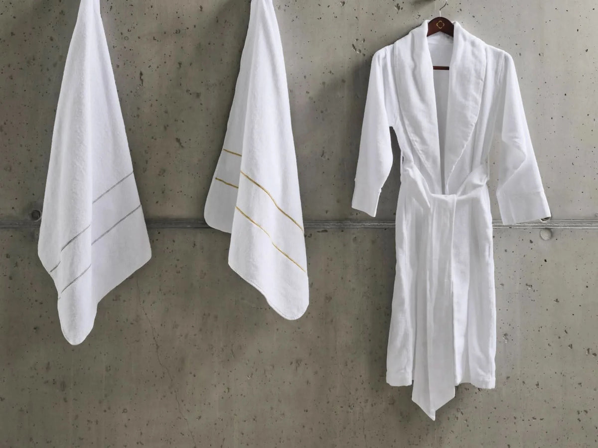 A&H Lara Embroidered Towels. Left: 109 Silver, Right: 108 Gold. A&H Amigo Robe in 100 White
