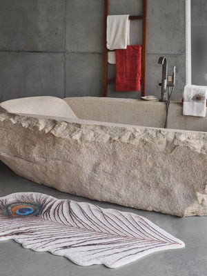 A&H Paon Bath Rug in 737 Caramel. 1,900 gsm 31 x 63". A&H Paleo hand towel next to tub filler. A&H Must Rug in 638 Chili (hanging)