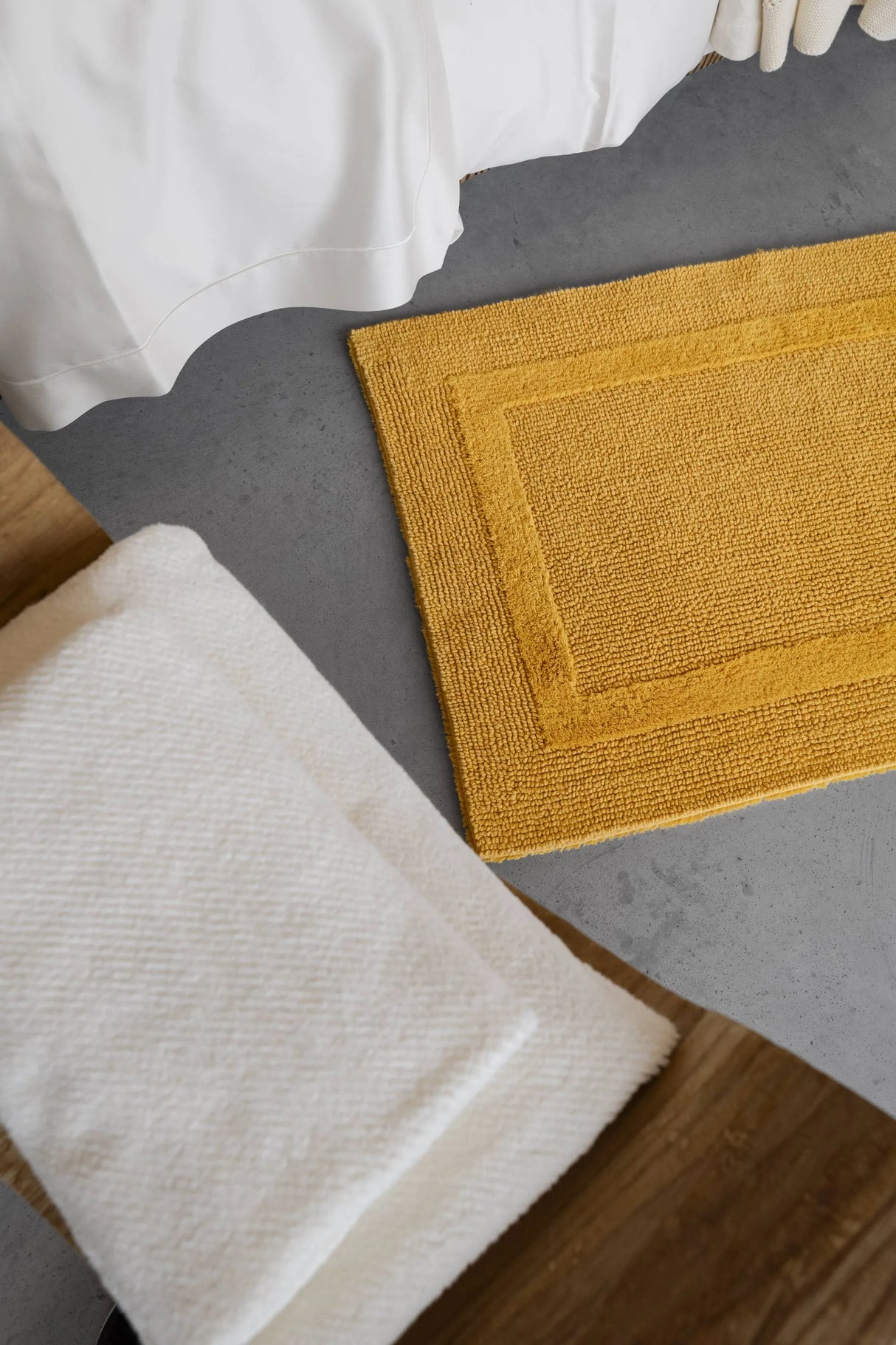 A&H Reversible Rug in 850 Safran. A&H Twill Towels in 103 Ivory