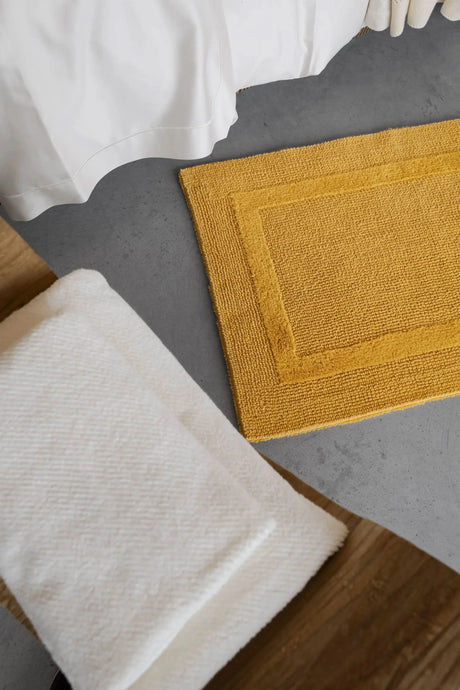 A&H Reversible Rug in 850 Safran. A&H Twill Towels in 103 Ivory