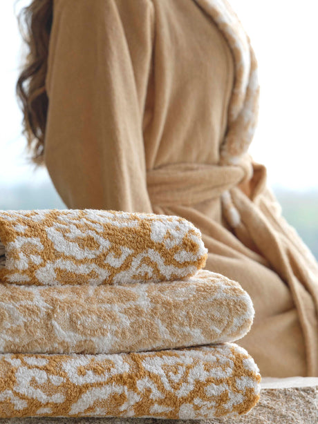 A&H Sauvage Towels, top-to-bottom: 840 Gold, 714 Sand, 840 Gold. A&H Sauvage Robe in 714 Sand