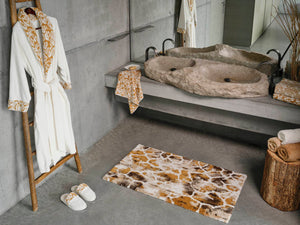 A&H Sauvage Towel in 840 Gold (left vanity), 714 Sand on 840 Gold (right vanity). A&H Sauvage Robe & Slippers in 840 Gold. A&H Gigi Rug in 840 Gold