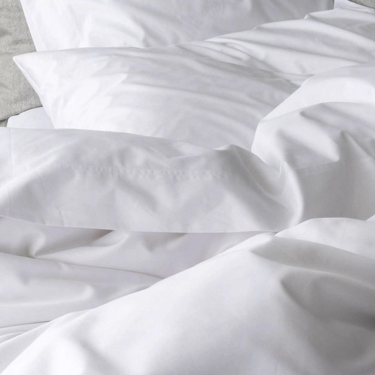 St Genève Sintra 300 thread count percale bedding in crisp white. Available in duvet covers, flat/fitted sheets, shams and pillowcases