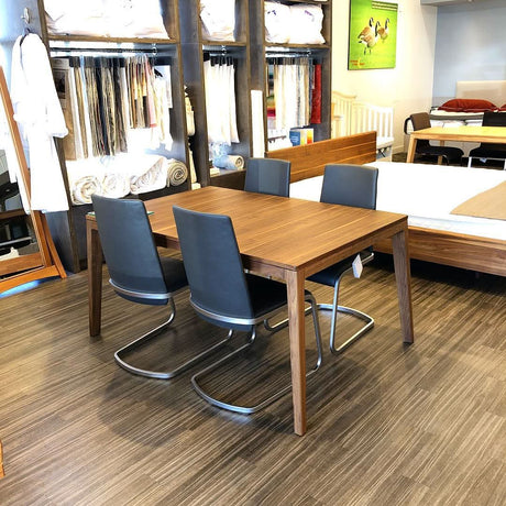 TEAM 7 mylon table in walnut w/ f1 chairs in anthracite leather. Photo: TMASC Calgary
