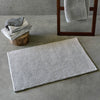 A&H Bay Bath Rug in 992 Platinum (bottom side shown on floor, top side hanging from ladder)